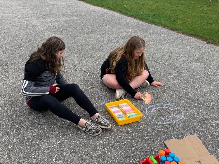 kids drawing with sidewalk chalk