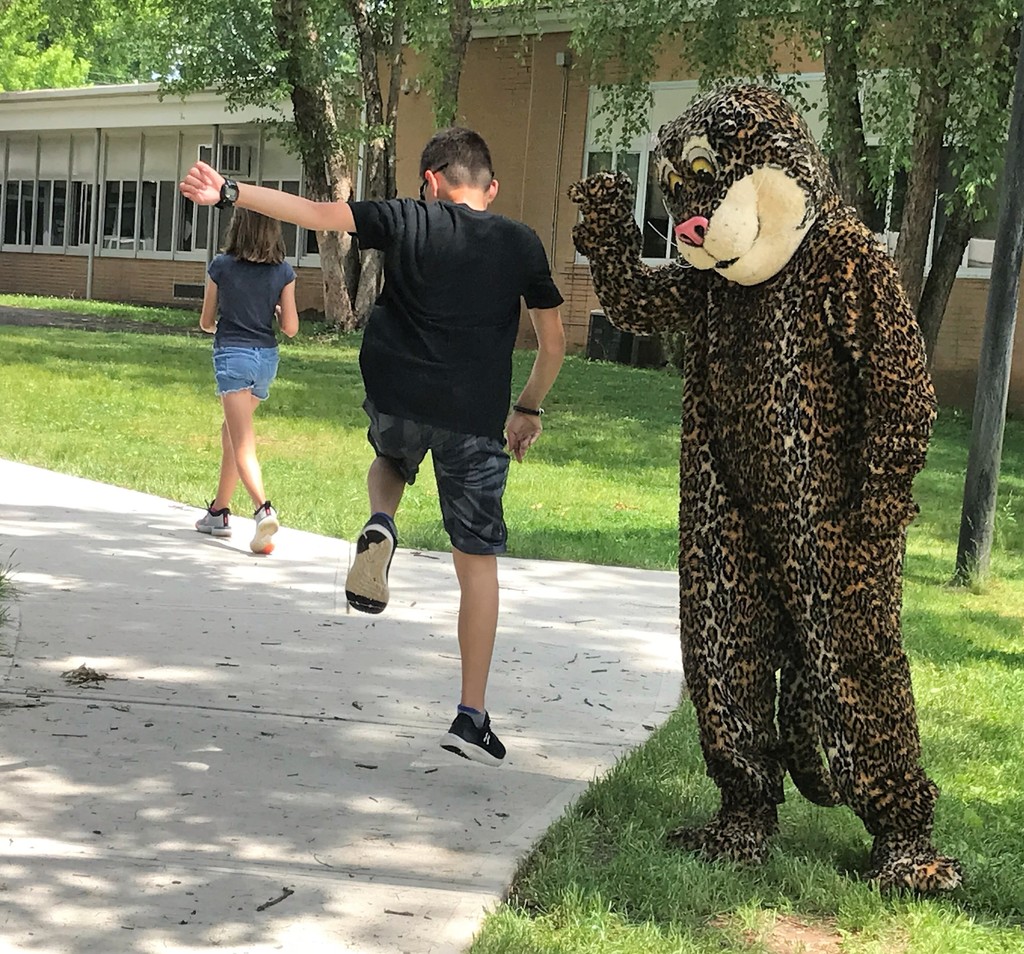 Jefferson student high fives with Jefferson Jaguar mascot