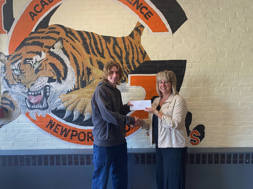 Eric Blaine accepting his scholarship from Christy Whipple