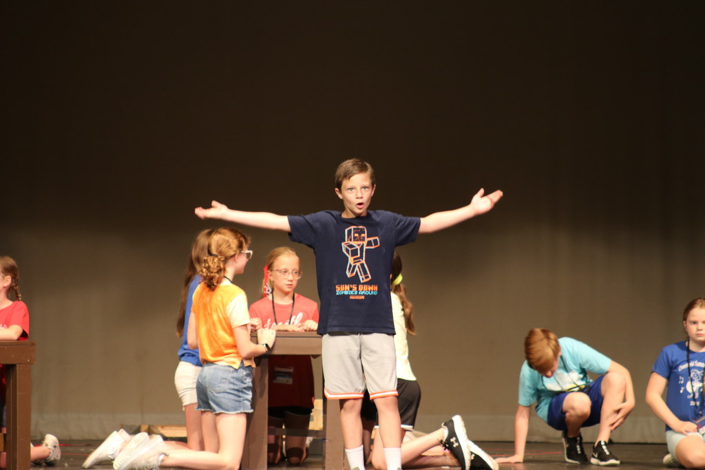 A student sings an song from Beauty and the Beast, Jr.