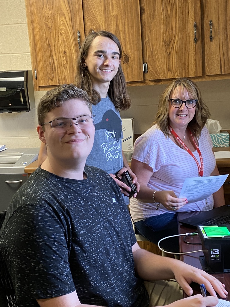 Brandon Hood and Connor Gibson getting fingerprinted.