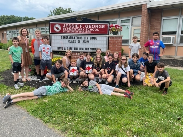 5th graders in front of JFG message board with a, "CONGRATULATIONS" message