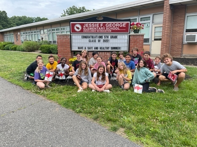 5th graders in front of JFG message board with a, "CONGRATULATIONS" message