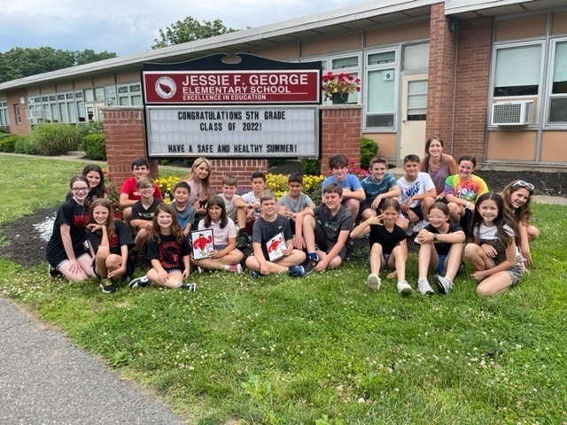 5th graders in front of JFG message board with a, "CONGRATULATIONS" message