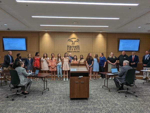 student athletes posing for award