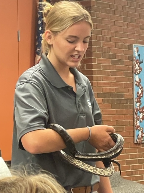 A naturalist with Brukner Nature Center shows a snake.