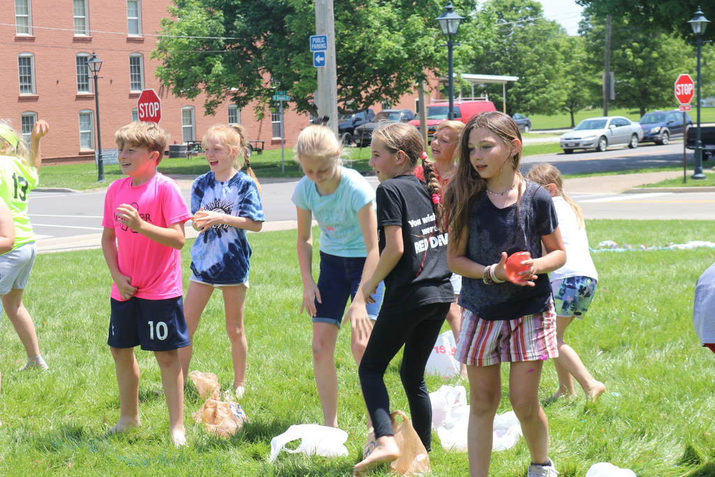 Students figure out their next moves for the water balloon toss.