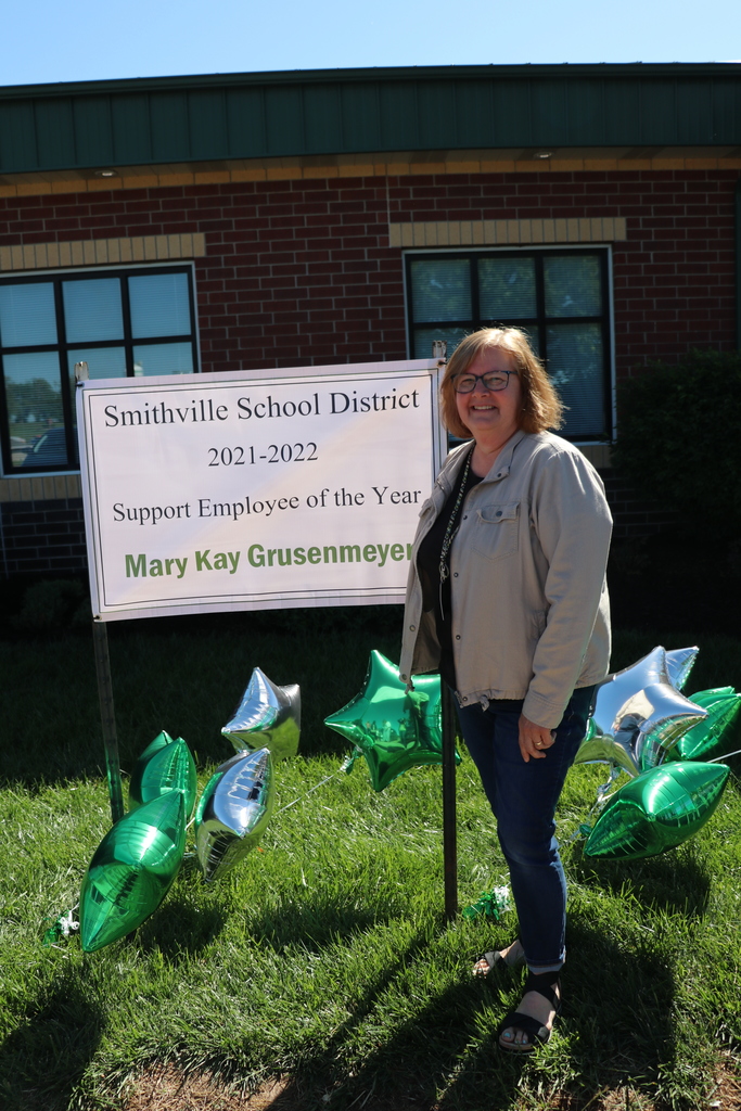 Mary Kay poses with banner