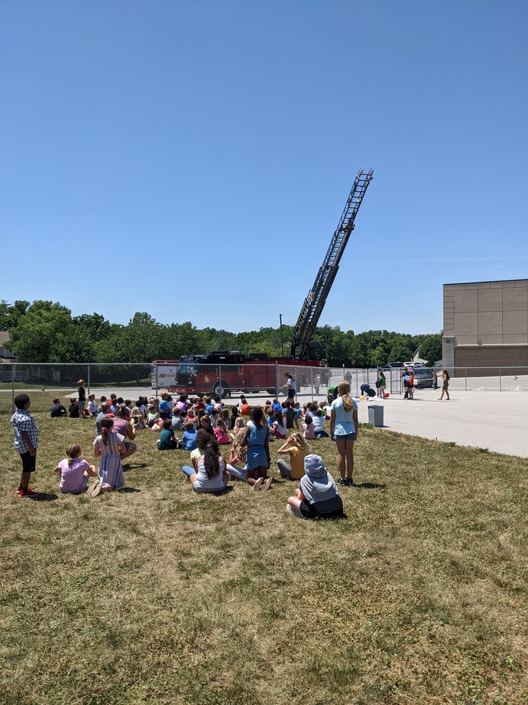 Students watch the eggs drop from the ladder