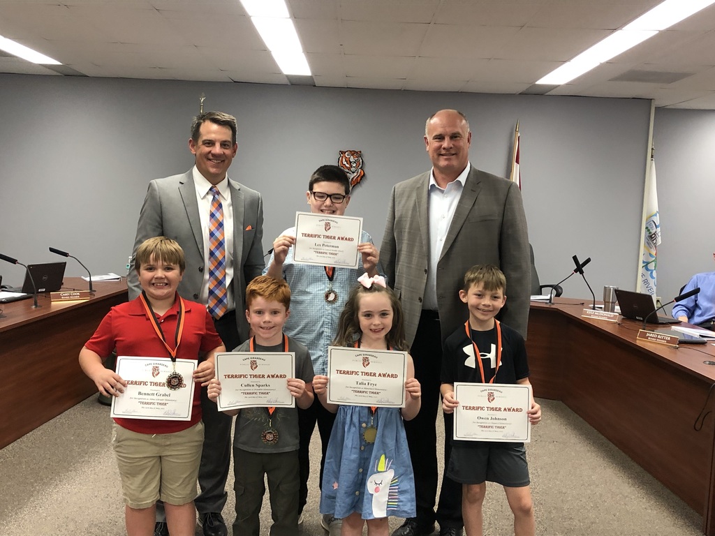 Dr. Glass and Board President Matt Welker pose with students who were honored as Terrific Tigers.