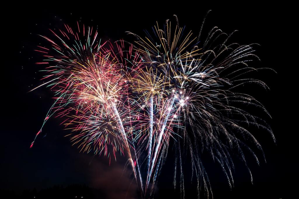 Black sky with fireworks finale exploding in splendor