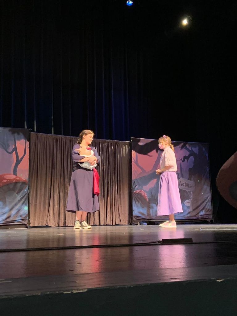 Students performing on stage.