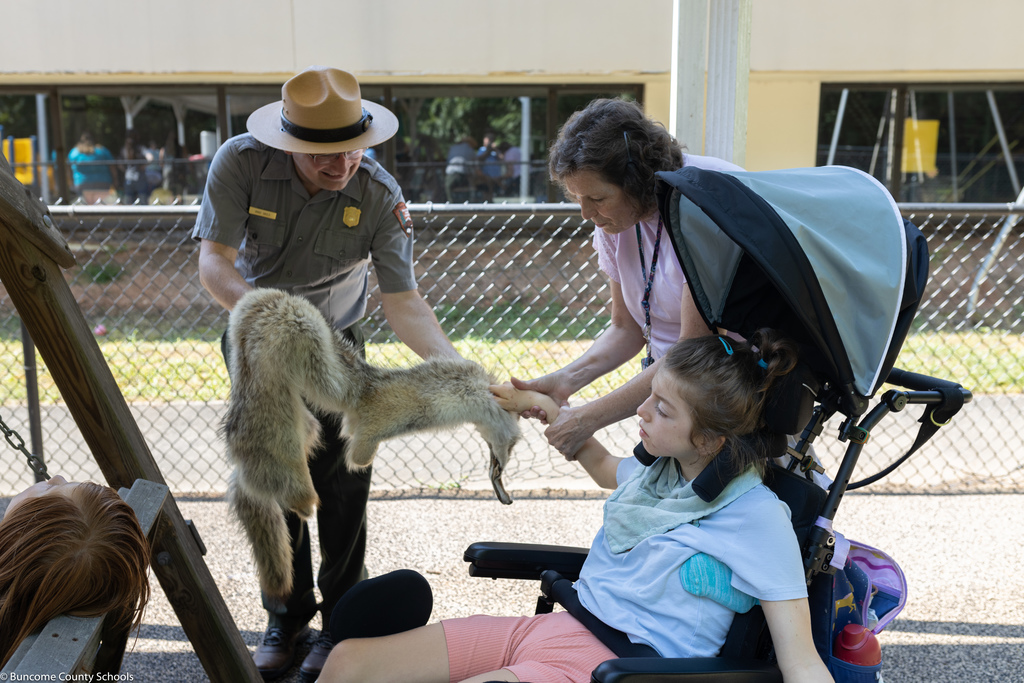 Students rubbing fox fur from Blue Ridge Parkway Ranger