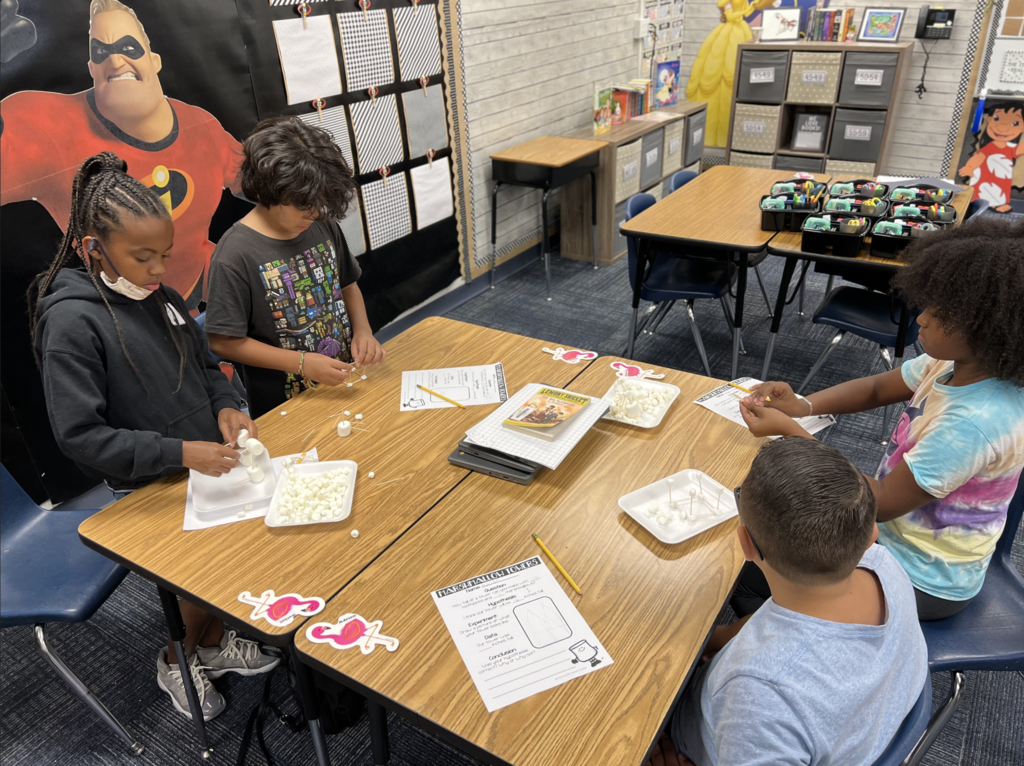 Students building towers with marshmallows and toothpicks.