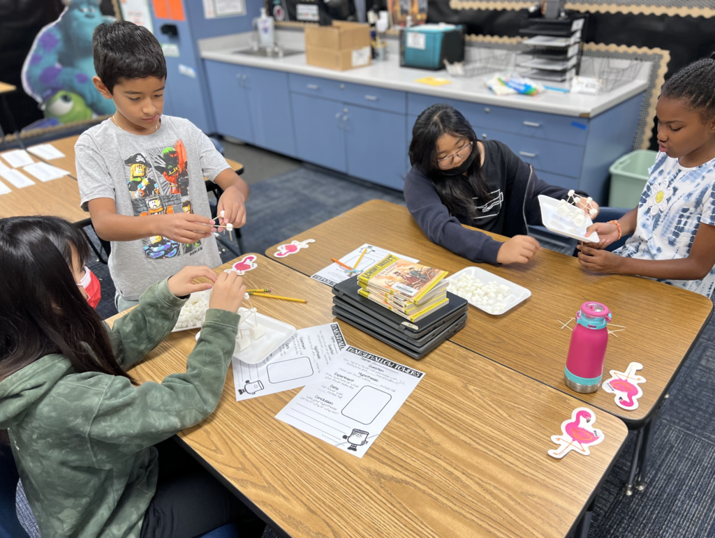 Students building towers with marshmallows and toothpicks
