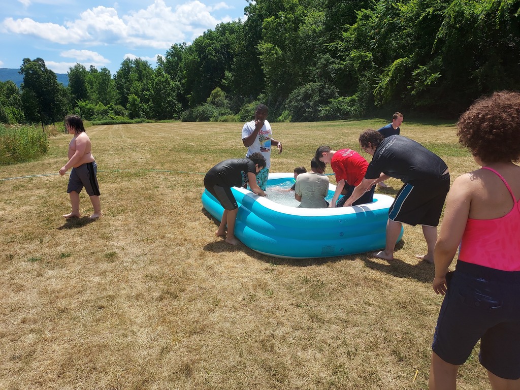 students playing in blue pool outside