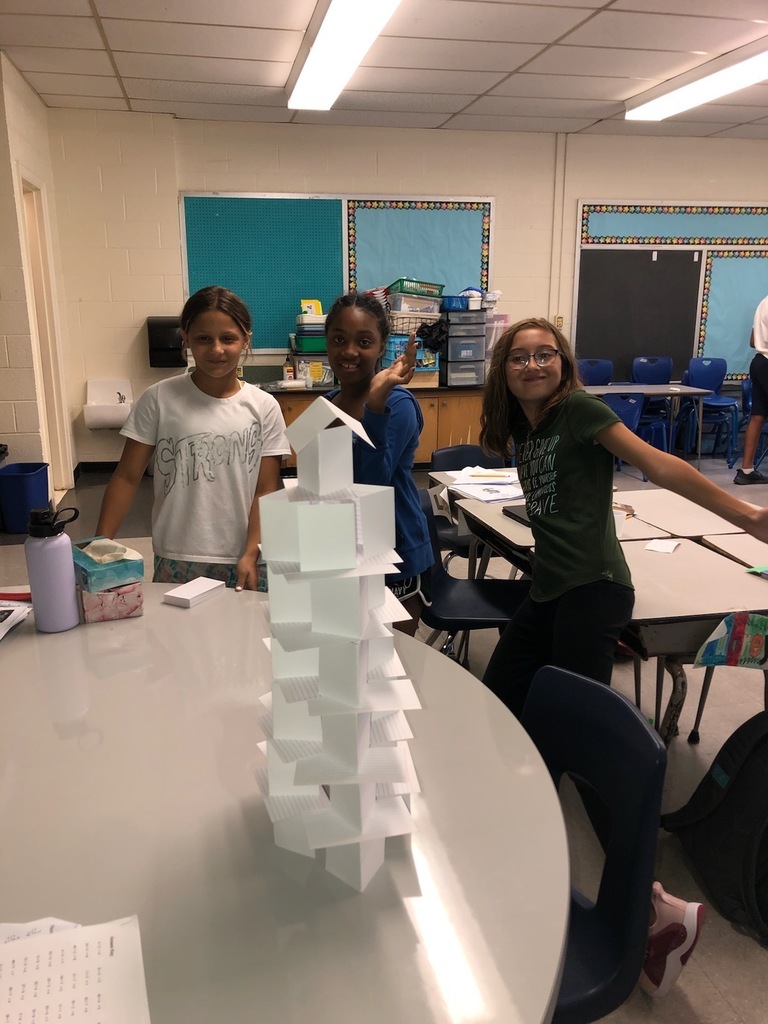 students building index card towers