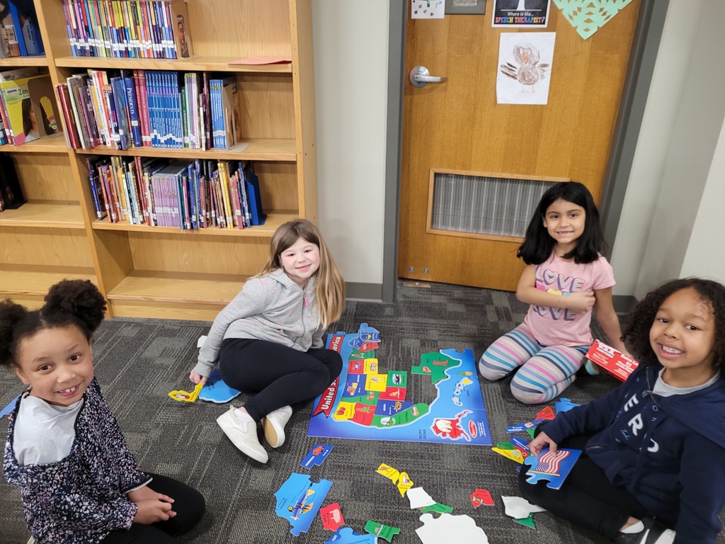 students doing a carpet puzzle
