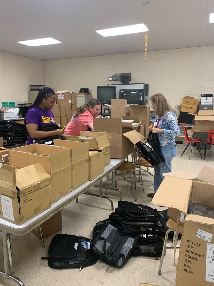 ladies packing backpacks 