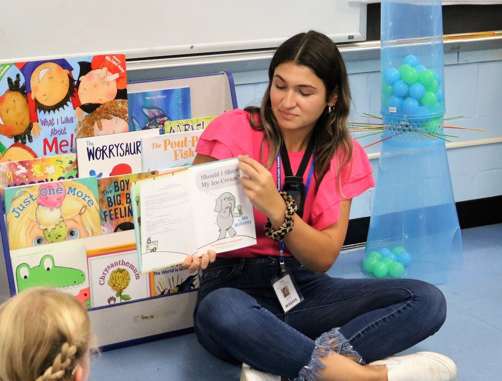 Extended School Year instructor reads to young learners.