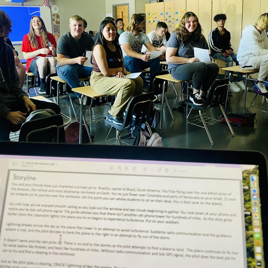 Students sitting on desks in the classroom working together