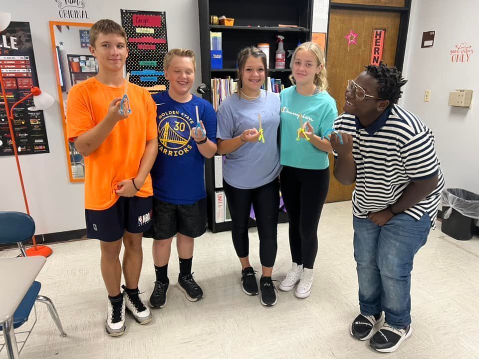 Mrs. Hernandez’s science classes balancing popsicle sticks on fingers with pipe cleaner