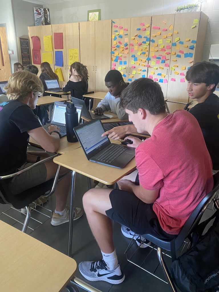 students working on their computers at their desk