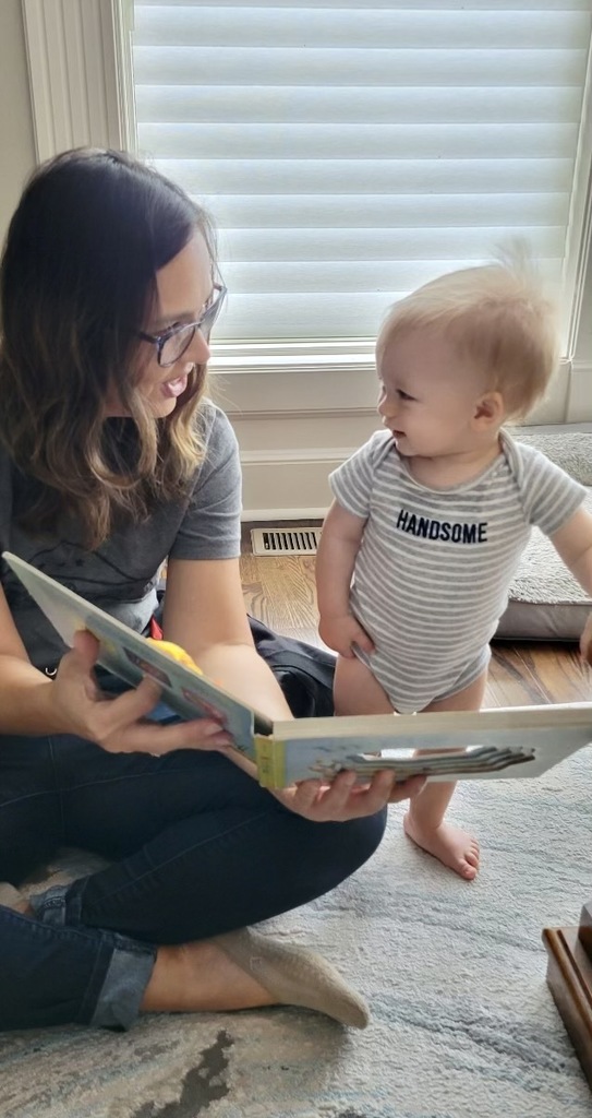 Parent educator reading to child.
