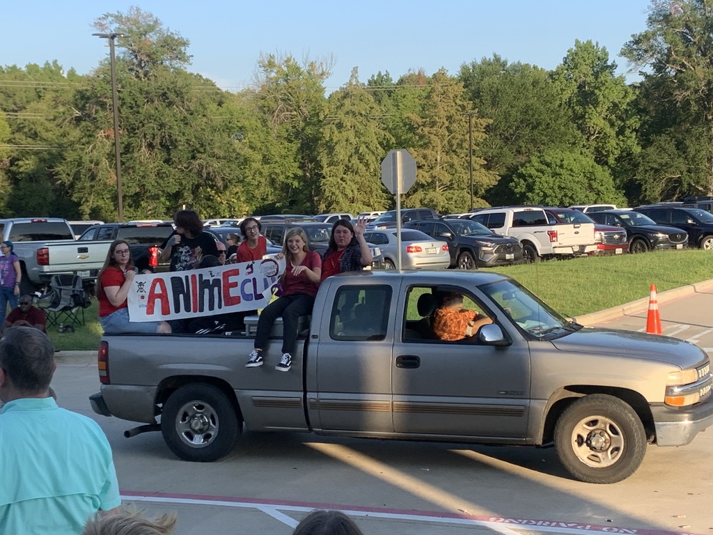 Anime club riding in a pickup at the homecoming parade.