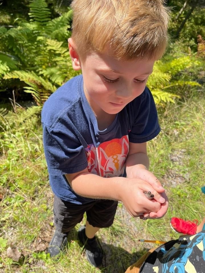 third grader holding a frog