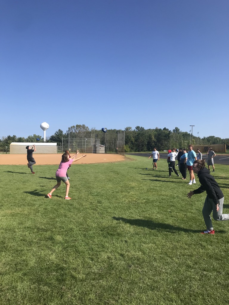 students playing football in a field