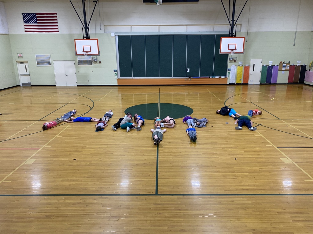 5th grade class spelling out happy on gym floor