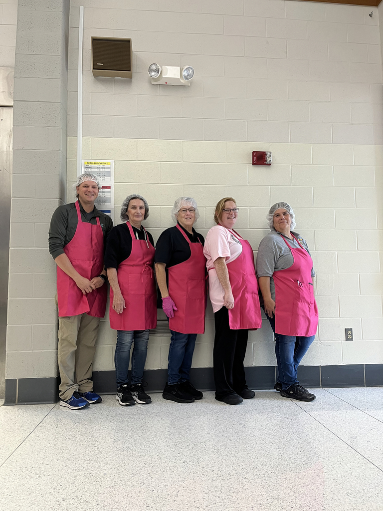 kitchen staff with pink aprons
