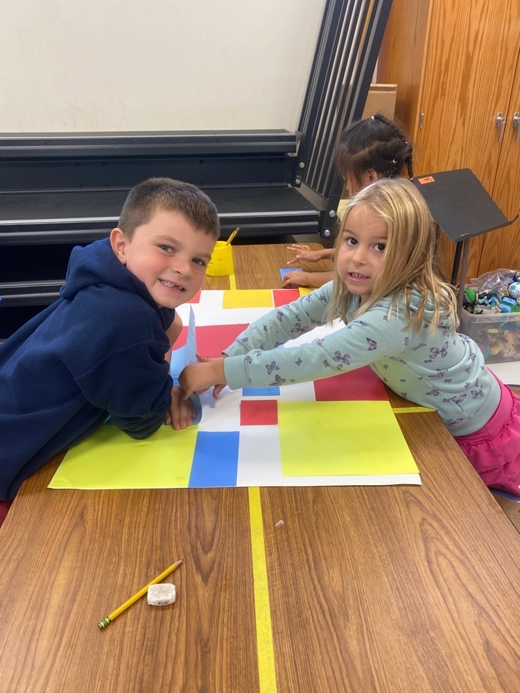 Two students doing Mondrian art designs. 