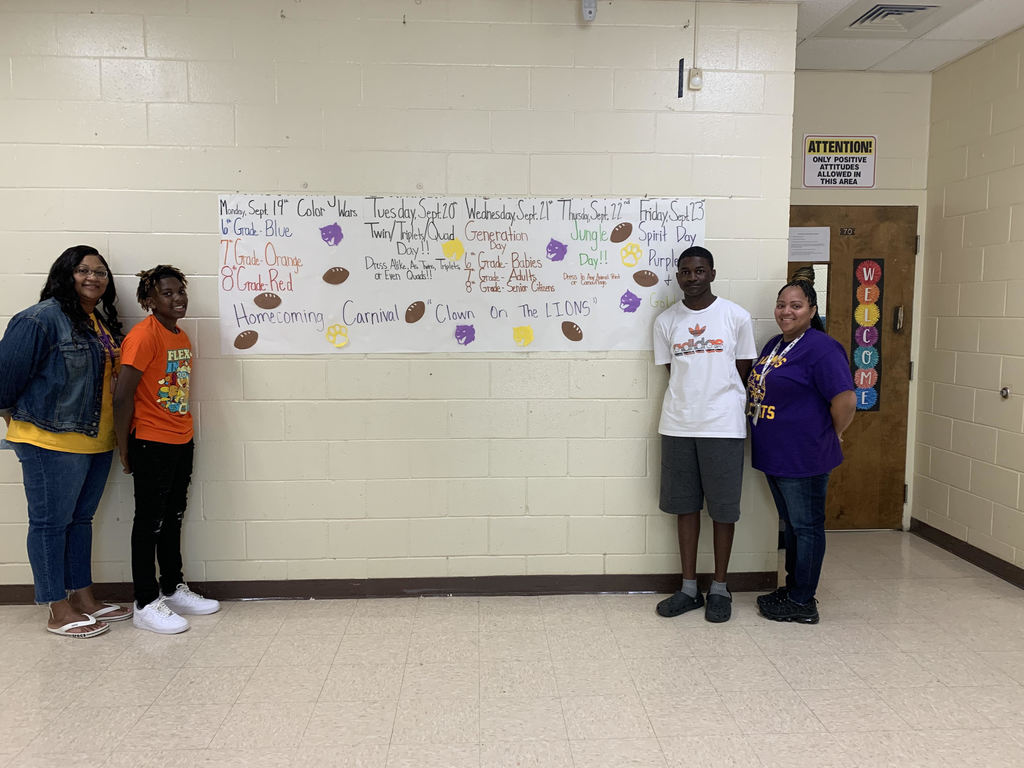 teachers and students with sign 