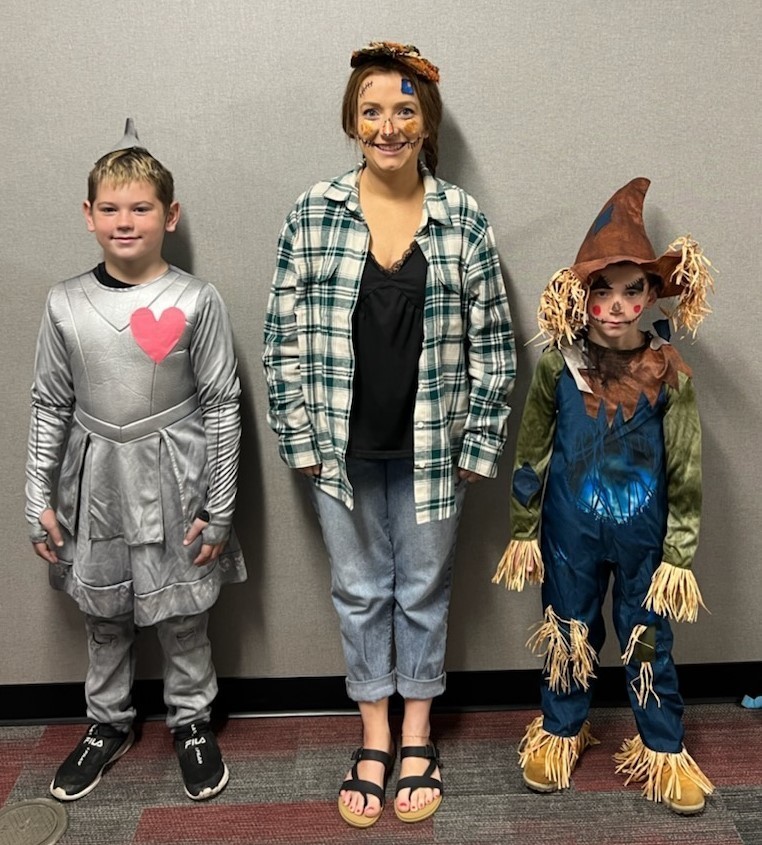 two students and a staff member dress up for Homecoming Spirit Week