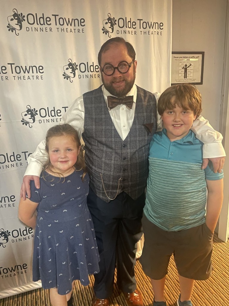 Students and a staff member at a theater.