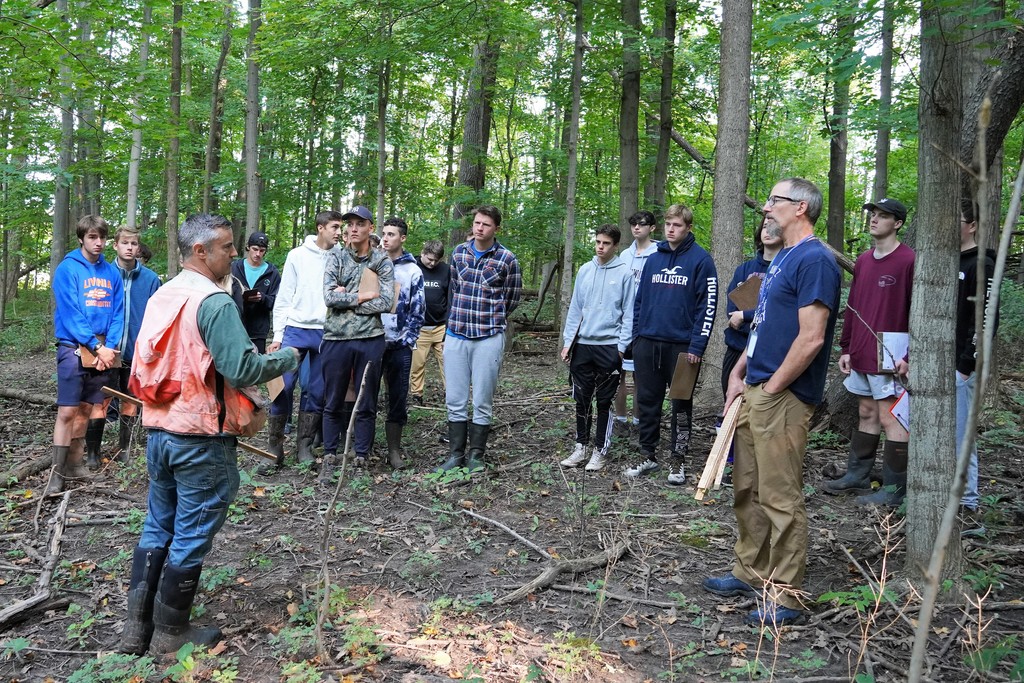 class in woods with DEC Forester