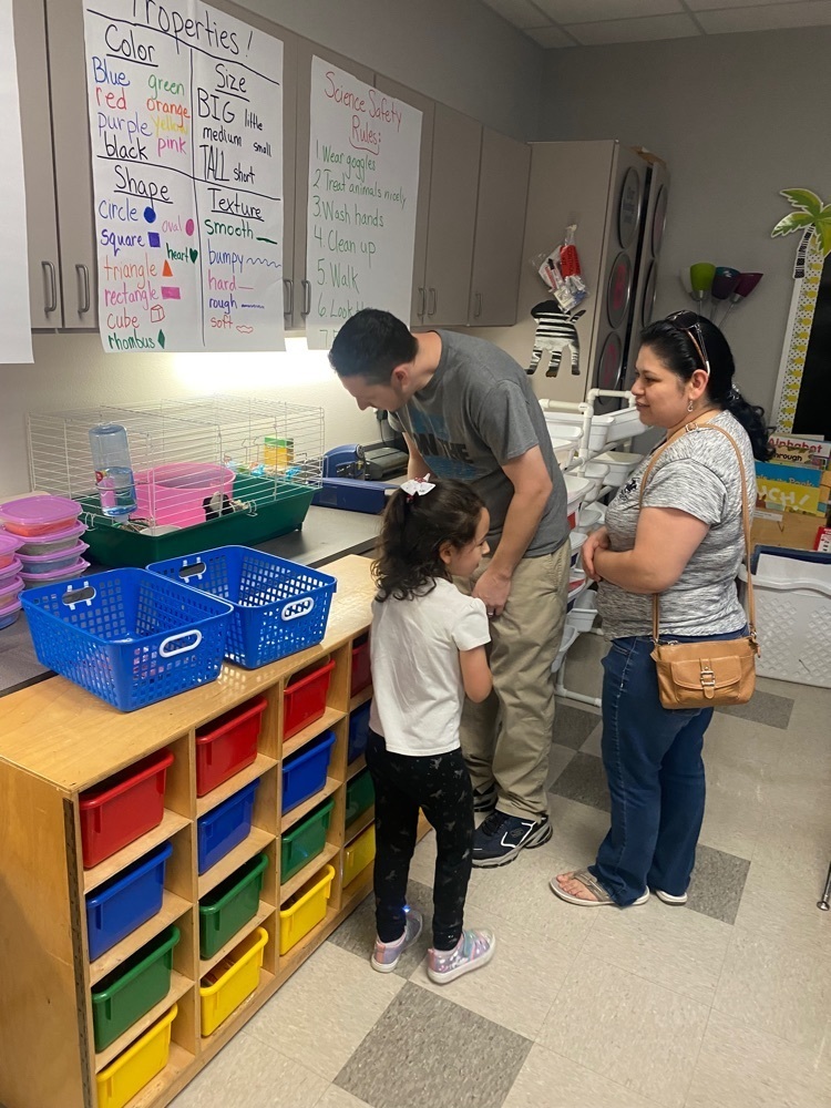 parent and students looking at displays