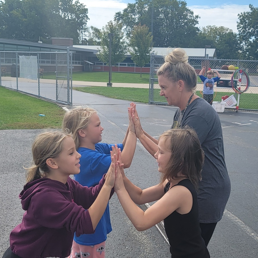 Teacher and students clapping hands together