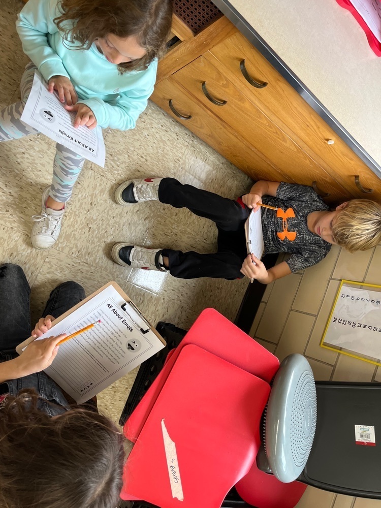 Third graders work together on paragraph response writing.