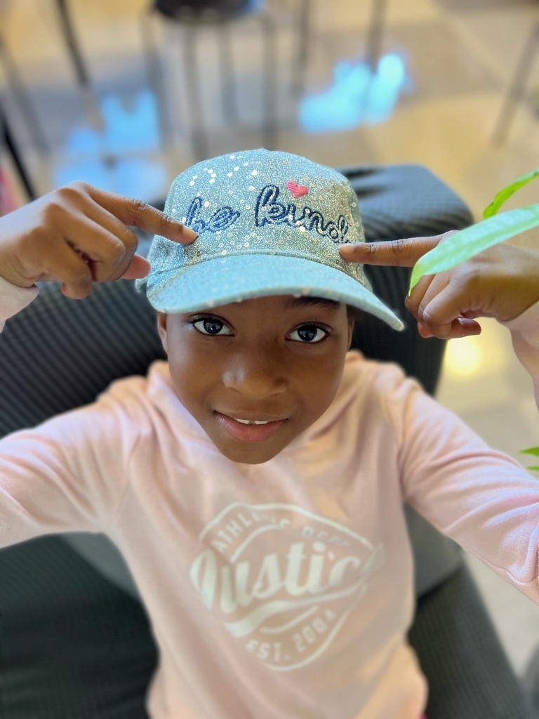 Girl wearing a Be Kind hat