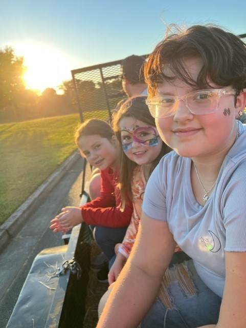 3 children on a "hay ride"