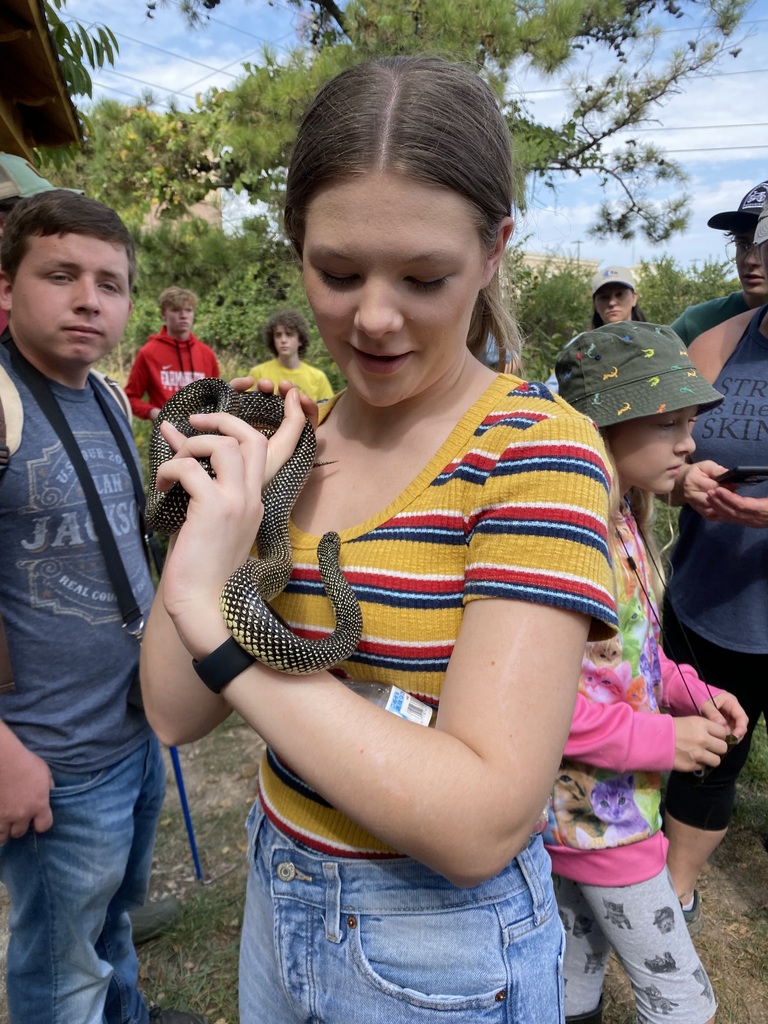 student holding a snake