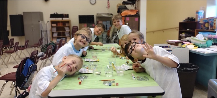 Students at after school program paint with watercolors