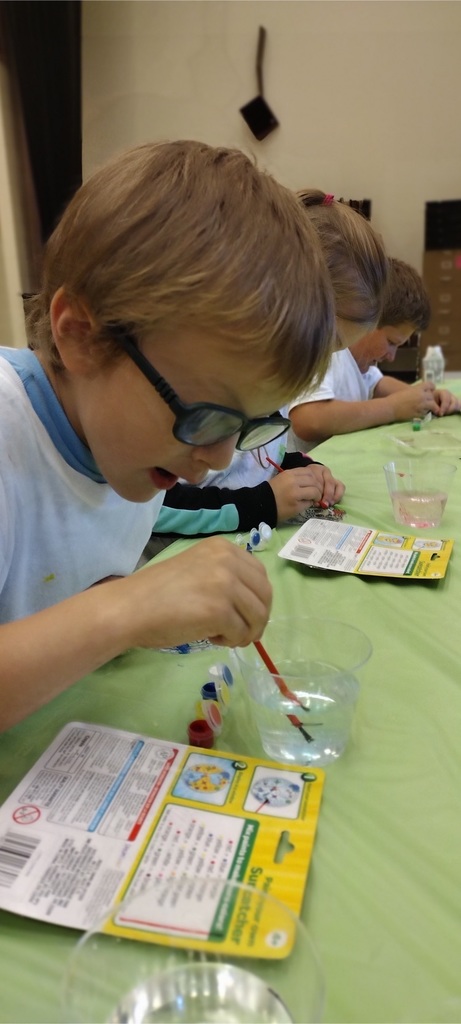 Students at afterschool program paint with watercolors