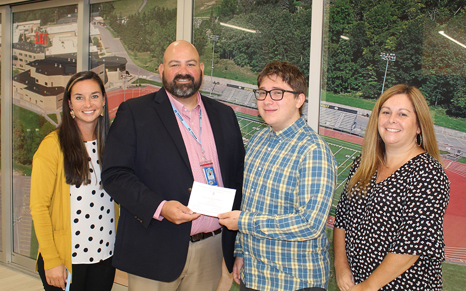 4 people - Ms. Hess, Mr. Keeler, Eamon, & Mrs. Darrow standing