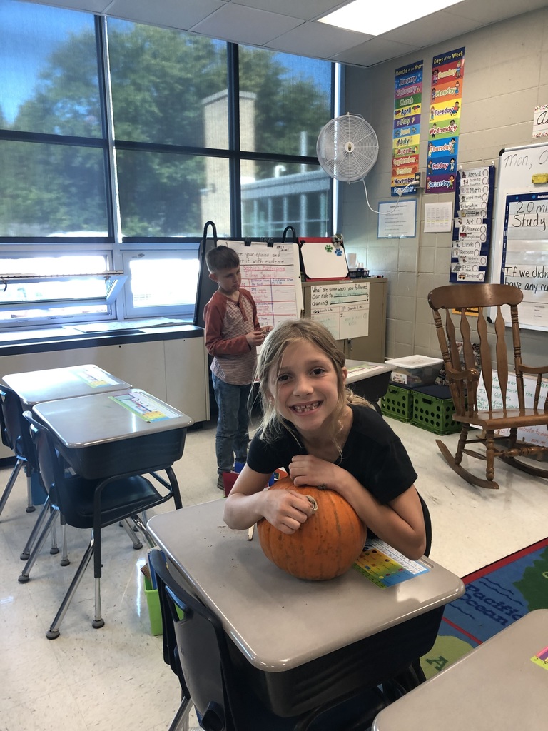 student with a pumpkin