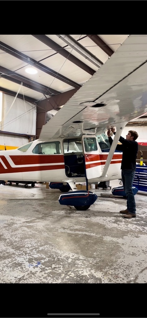 pulling off check panels to inspect Aileron cable tension