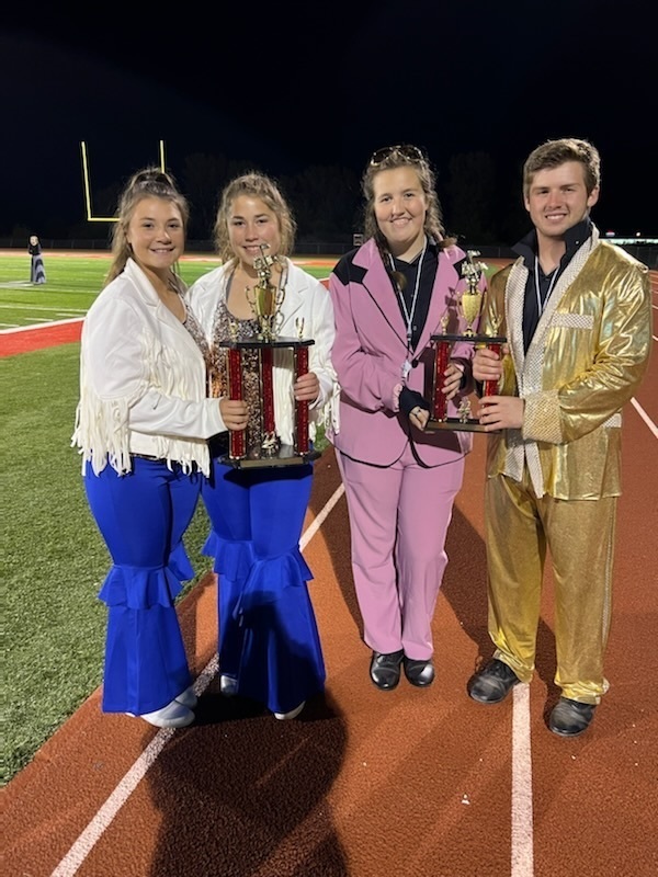 Color Guard Captains Emily Sparrow and Ellie Goehl along with drum majors Faith Post and Will Goings Pose with the trophies